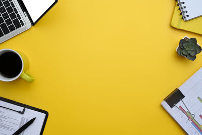 Directly above shot of objects on yellow background