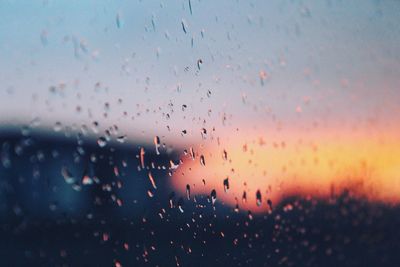 Waterdrops on glass against blurred background