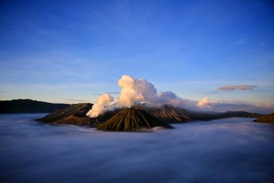 Scenic view of mountains against blue sky at sunset