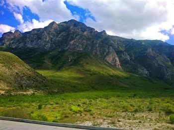 Scenic view of mountains against cloudy sky