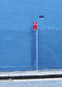 Close-up of sign on blue door