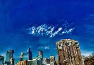 Low angle view of buildings against blue sky