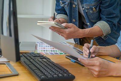 Low angle view of woman working on table