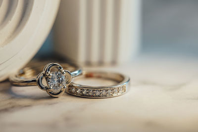 Close-up of wedding rings on table