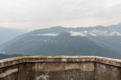 View of mountain range against cloudy sky