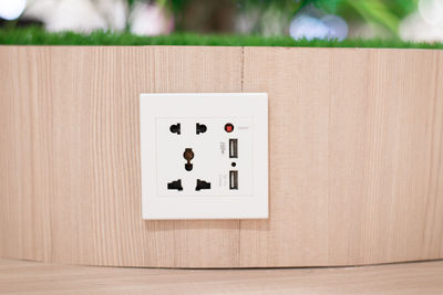 Directly above shot of telephone booth on table against wall