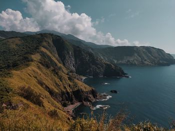 Scenic view of sea and mountains against sky