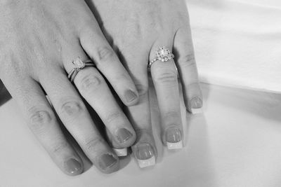 Cropped hands of brides wearing wedding rings