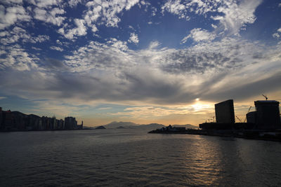 Scenic view of sea and buildings against sky during sunset