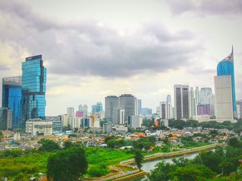 Skyscrapers against cloudy sky