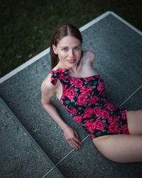 Portrait of a smiling young woman sitting outdoors