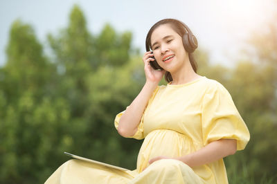 Young woman using smart phone outdoors