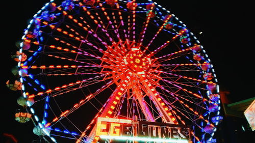 Low angle view of ferris wheel against sky at night