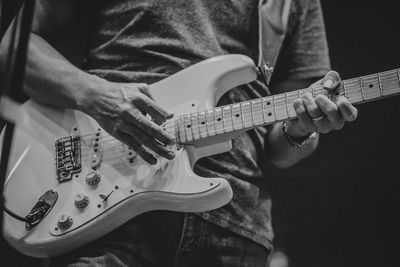 Close-up of man playing guitar