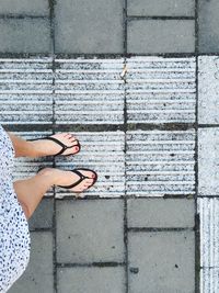 Low section of woman standing on street