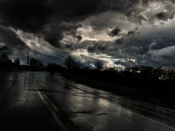 Scenic view of road against dramatic sky