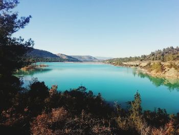 Scenic view of lake against clear blue sky