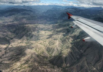 Cropped image of airplane flying over landscape