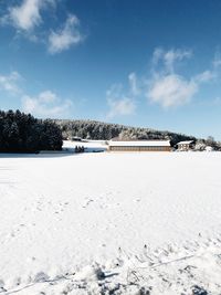 Snow covered field against sky