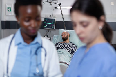 Portrait of doctor examining patient at clinic