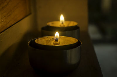 Close-up of lit tea light candles in temple