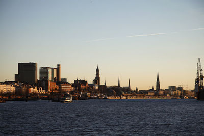 River in city against clear sky