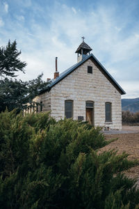 Exterior of house on field against sky