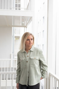 Portrait of young woman standing in city