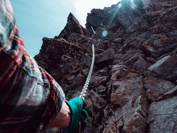 Low section of man standing on rock