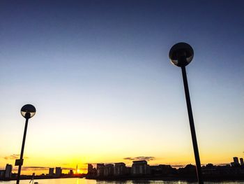 Low angle view of illuminated street light against clear sky