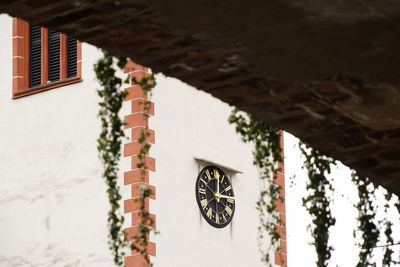 Low angle view of  clock on wall of church