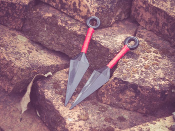 High angle view of hand tools on rocks