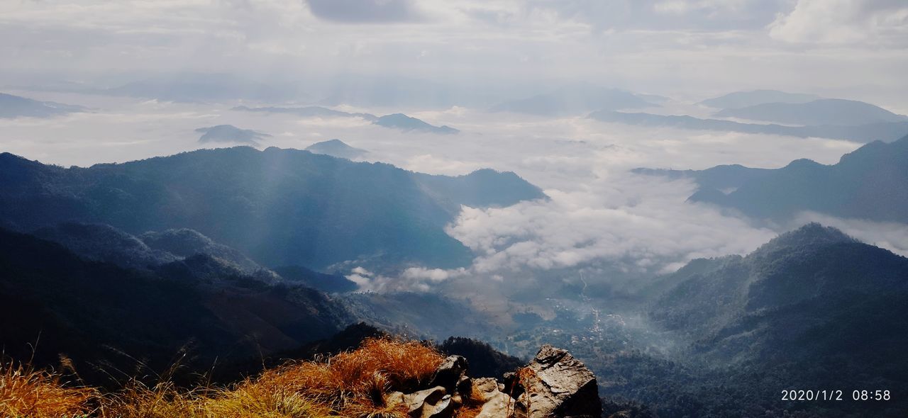 AERIAL VIEW OF CLOUDS OVER MOUNTAIN