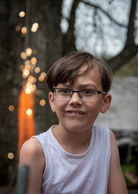 Portrait of smiling boy against trees