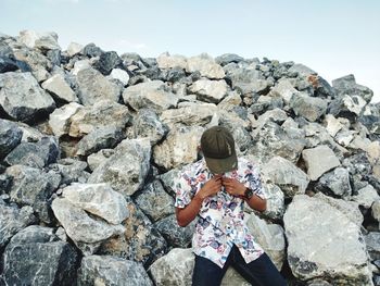 Rear view of woman standing on rock