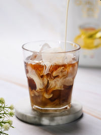 Close-up of milk being poured in coffee