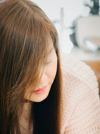 Close-up portrait of a serious woman at home