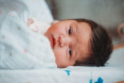Newborn baby girl in hospital eyes wide open