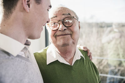 Senior man smiling at young man