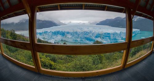 Scenic  glacier view of  against sky seen through window