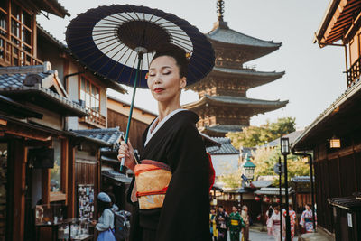 Woman standing against buildings