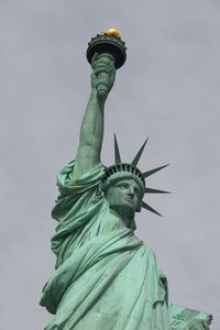 Close-up of statue of liberty against sky