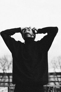 Full length of young man standing against wall