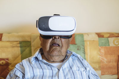 Man wearing virtual reality simulator at home