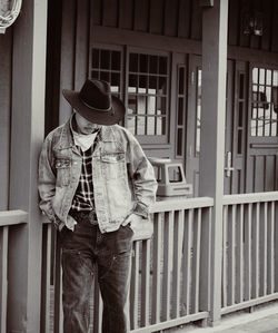 Rear view of woman standing against railing