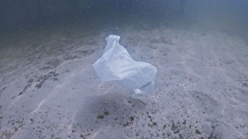 High angle view of garbage on sand at beach