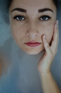 Close-up portrait of woman in bathtub