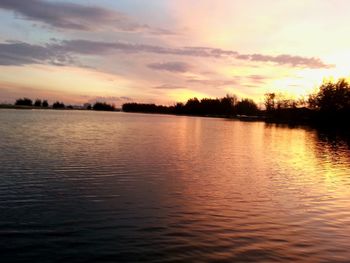 Scenic view of lake at sunset