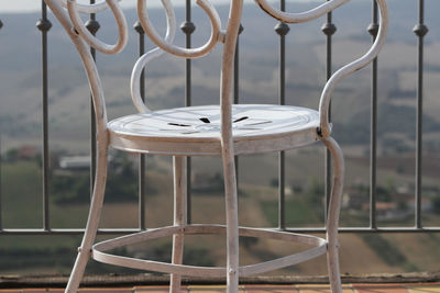 Detail of white chair in the foreground. panorama in the background