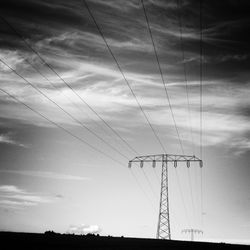 Low angle view of electricity pylon against sky